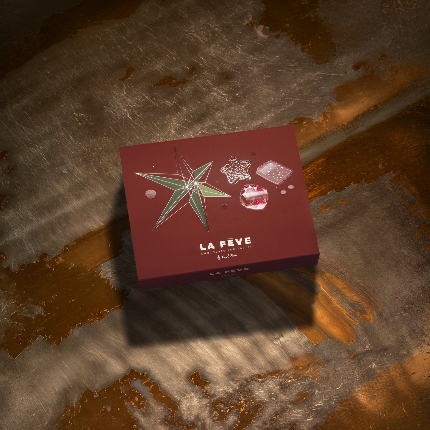 Red box with star design labeled 'La Fève' on a textured surface