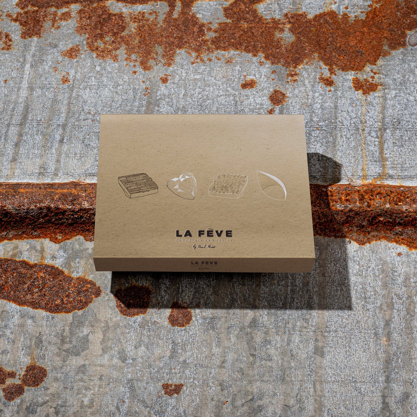 La Feve eco-friendly kraft paper packaging on a textured metal background