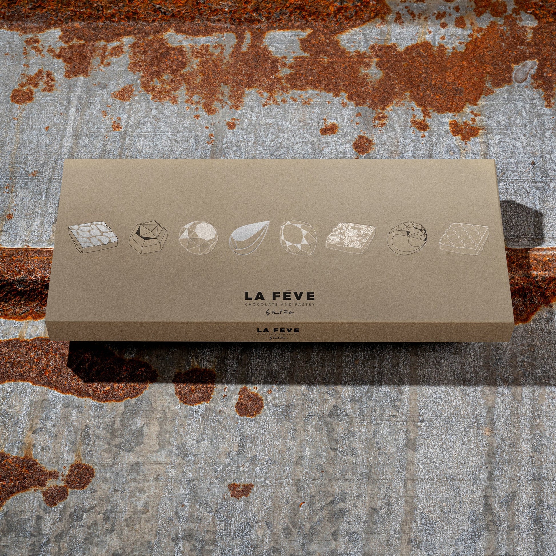 La Féve eco-friendly kraft packaging on a textured metal background