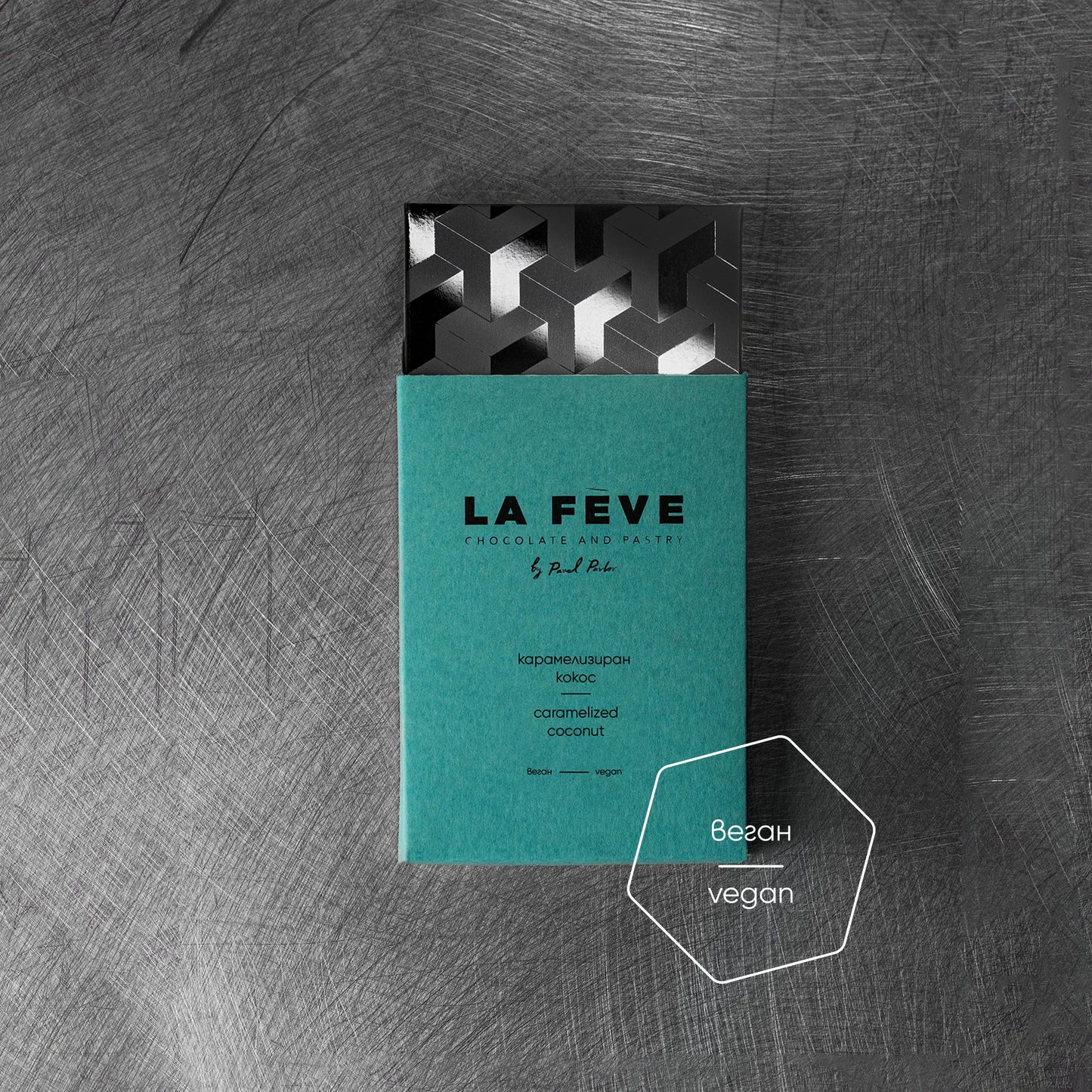 Teal chocolate bar packaging on a textured gray background