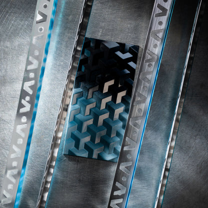 Teal chocolate bar with geometric design close up on a metal textured surface