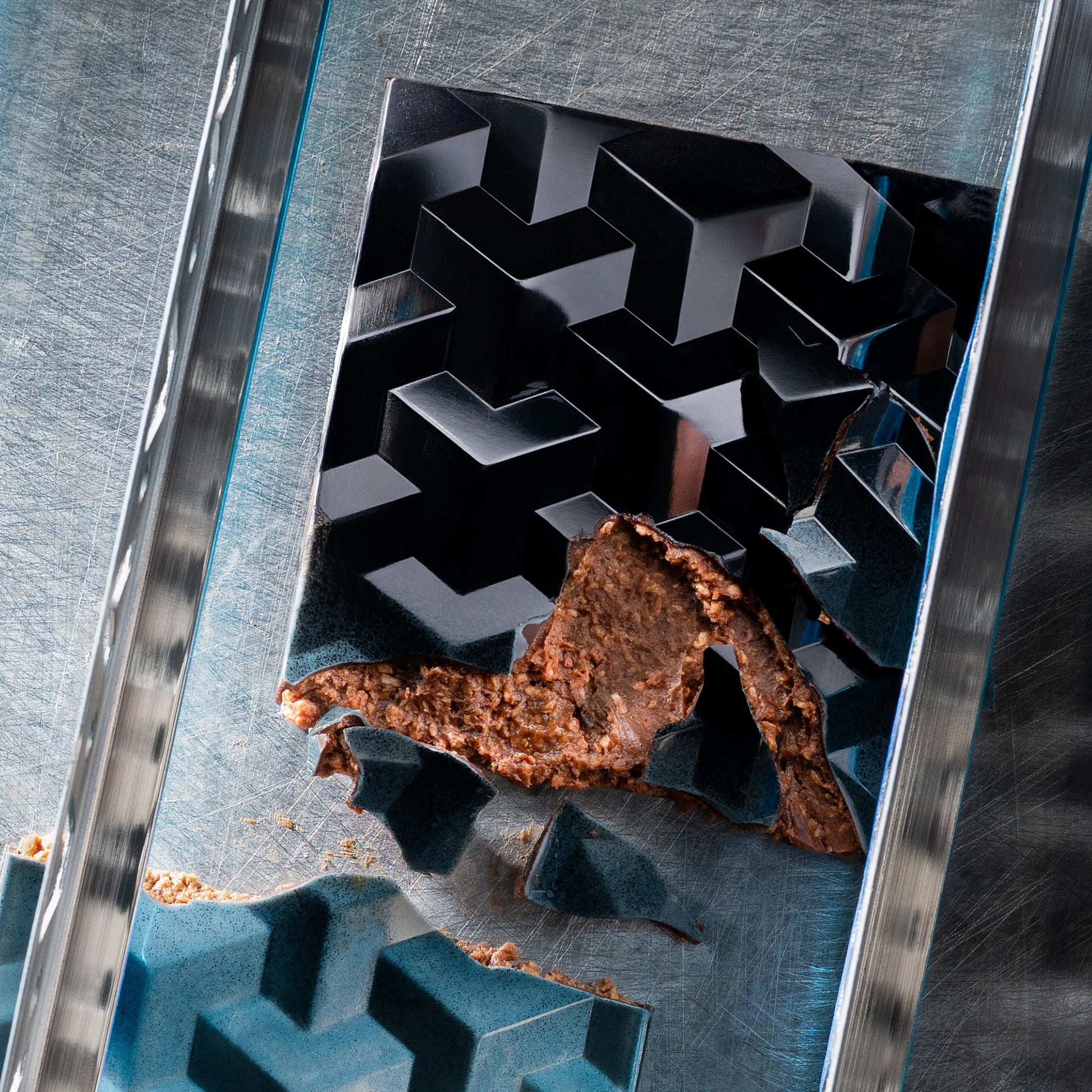 Teal chocolate bar cut close up praline inside showing