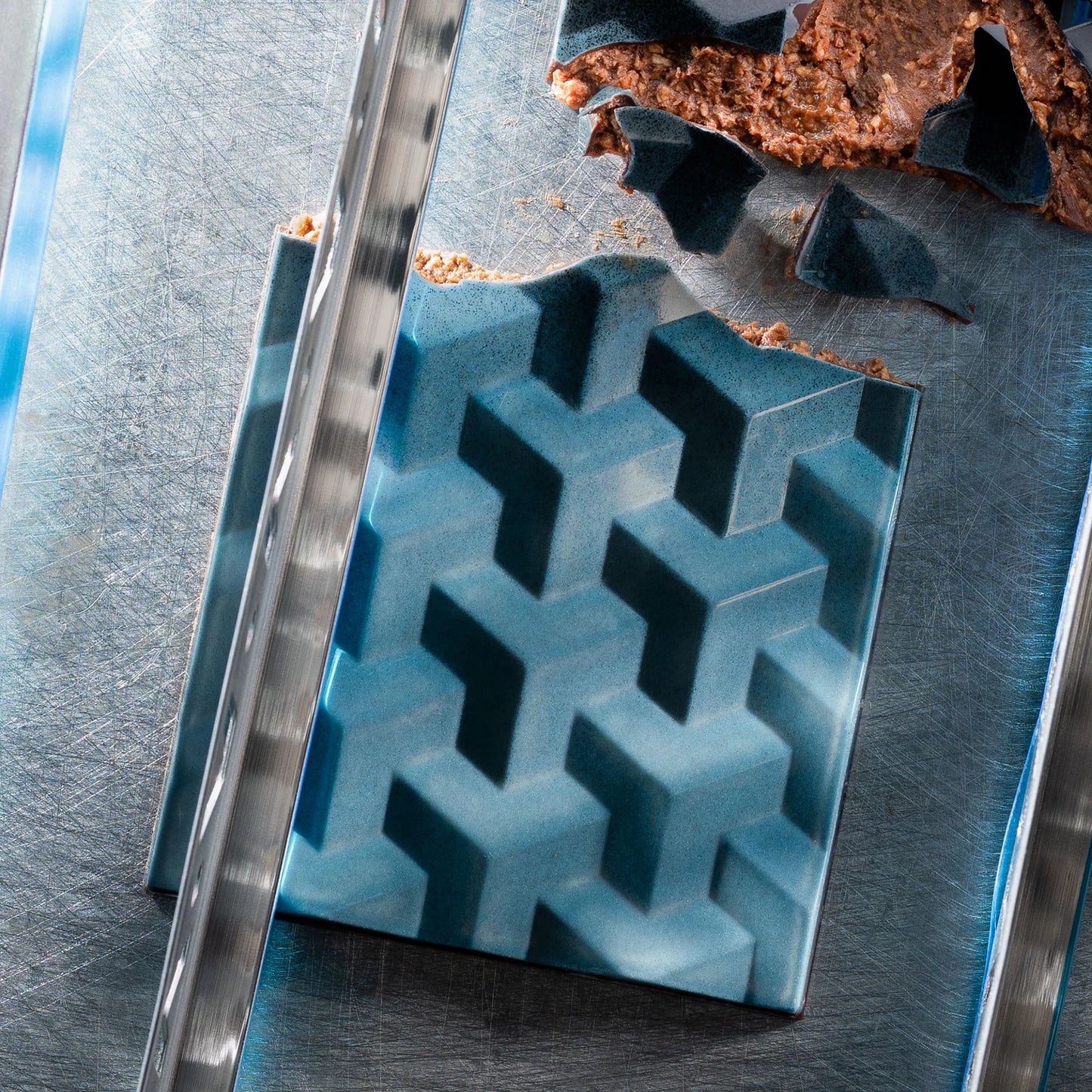 Teal chocolate bar cut close up praline inside showing