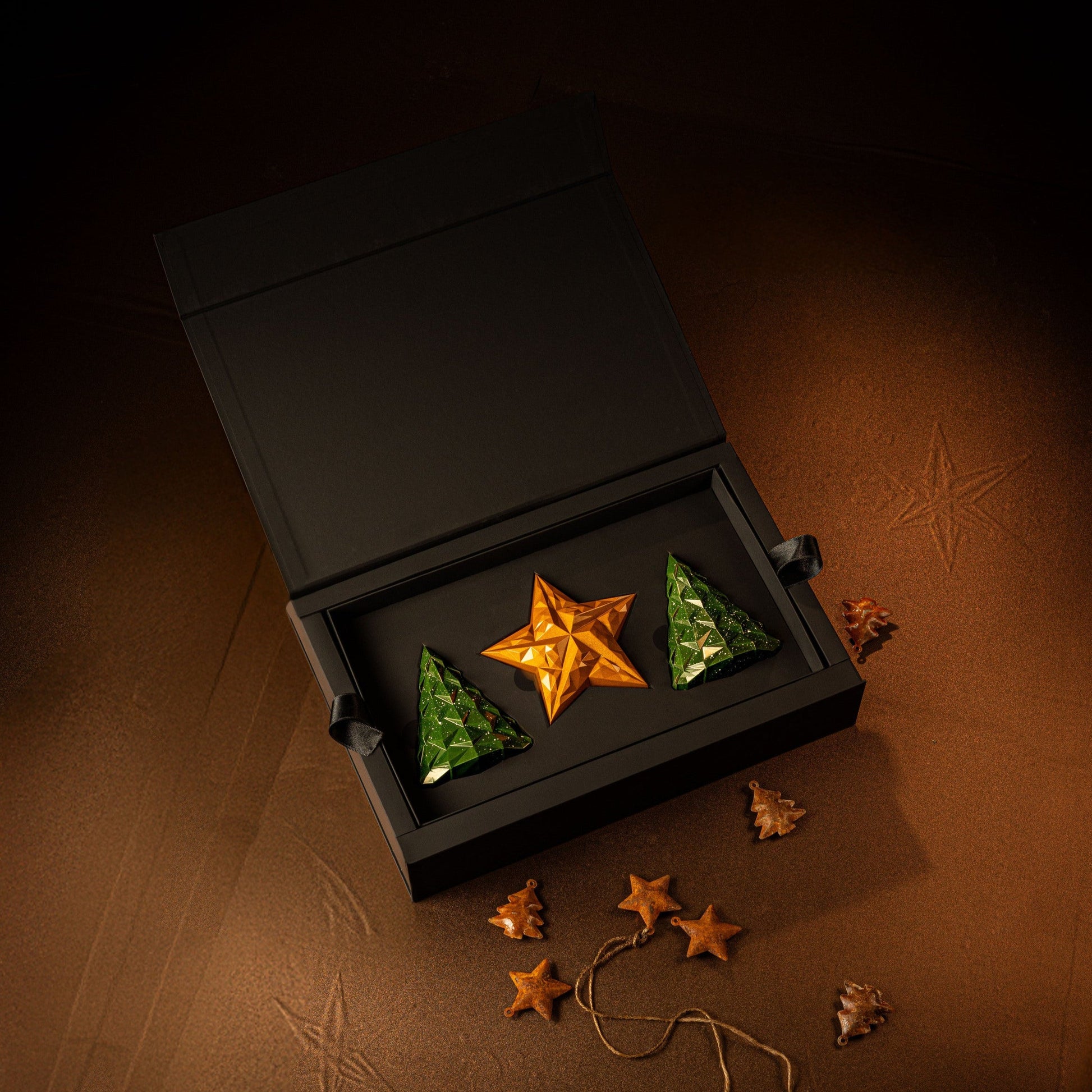 Decorative star-shaped chocolates in a black box on a wooden surface