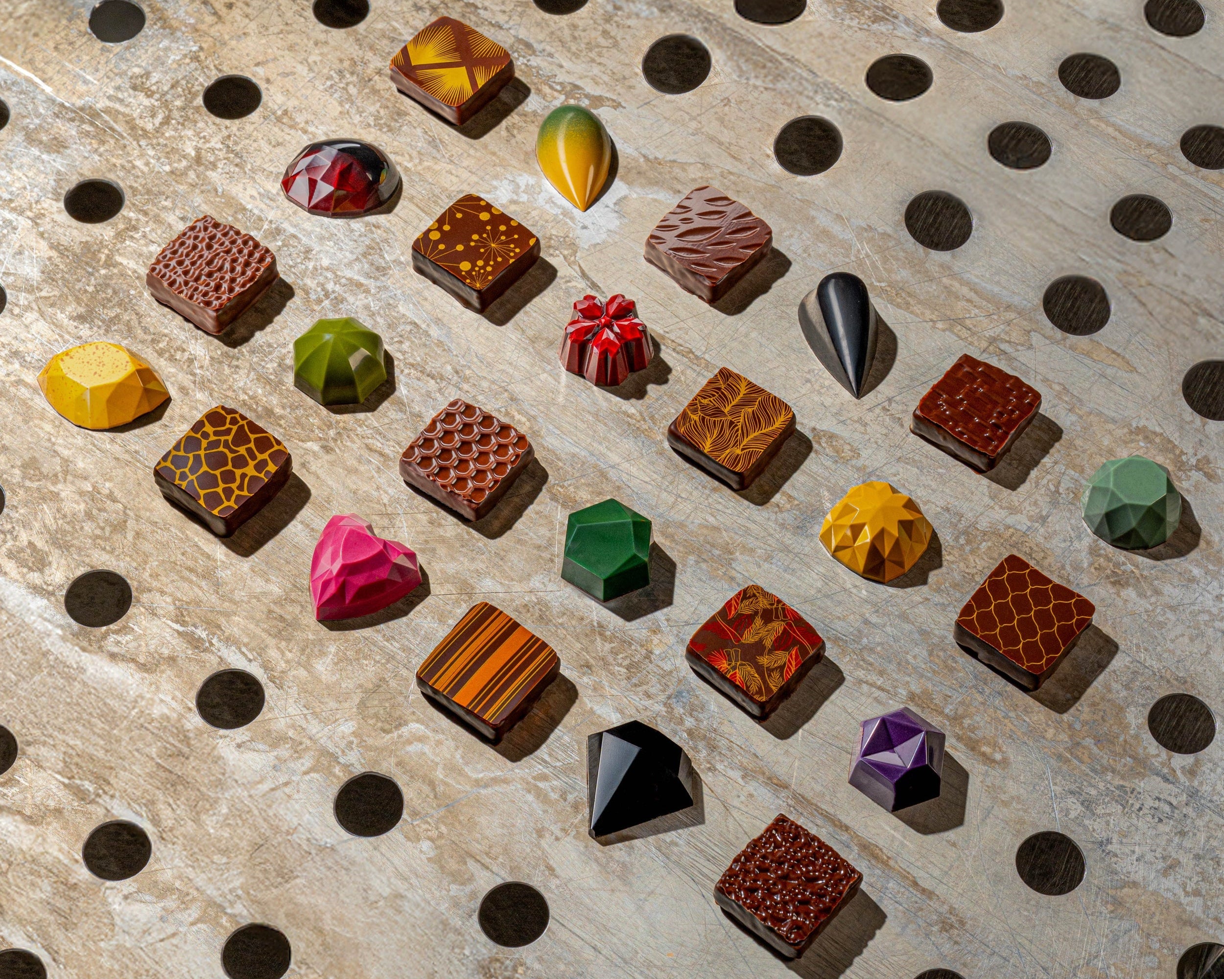 Colorful gemstone-like candies on a textured surface