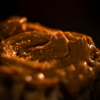 Close-up of a spread on a bread roll with a dark background